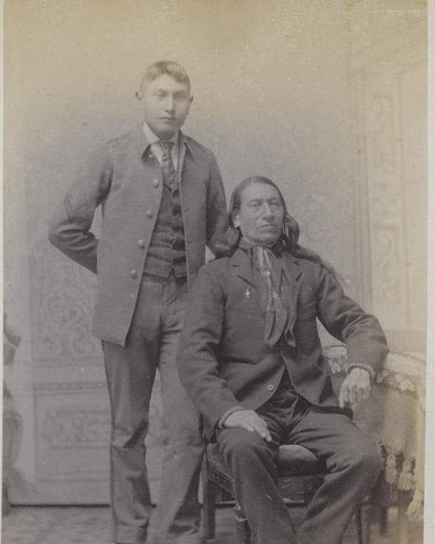 Chief Charging Shield, Oglala Sioux Tribe, seated, was photographed in 1892 with an Oglala Sioux student, Samuel Flying Horse, at the Carlisle Indian Industrial School. The chief had traveled to the school to visit his sick daughter, Fanny Charging Shield, who died March 7, 1892, a few weeks after his visit. Flying Horse died the following year, also from consumption. The remains of Fanny Charging Shield and Flying Horse are set to be returned to their tribes and family in the fall of 2024. (Historic photo via Cumberland County Historical Society)