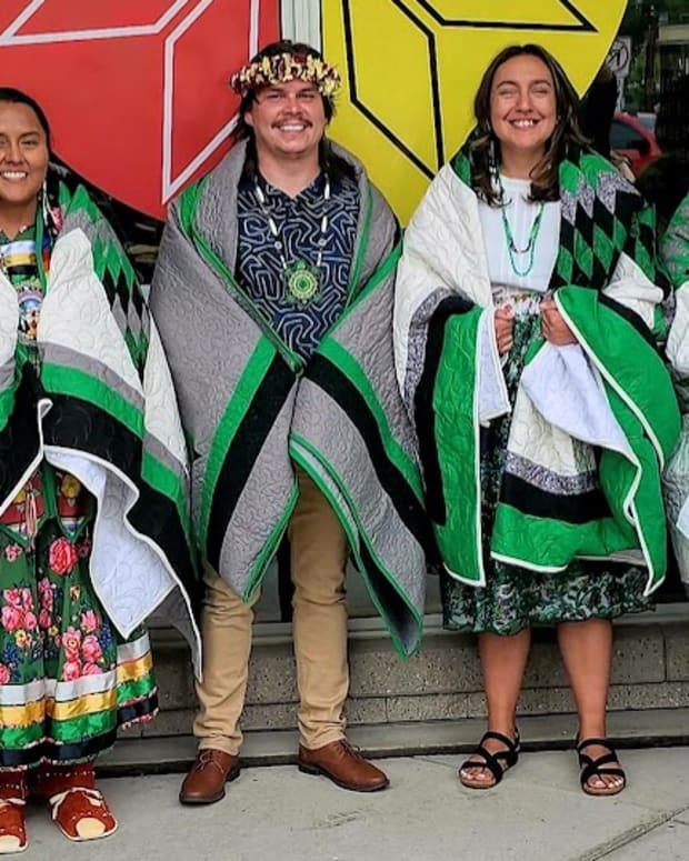 First-ever Ph.D. graduates in Indigenous Health at the University of North Dakota are, from left, Danya Carroll, Cole Allick, Amy Stiffarm and Mona Zuffante. All wear star quilts that the department – under the auspices of the School of Medicine and Health Sciences – gifted them. (Photo courtesy of the University of North Dakota)