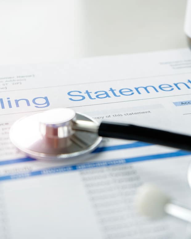 Health care billing statement with stethoscope, bottle of medicine for doctor's work in medical center stone background.