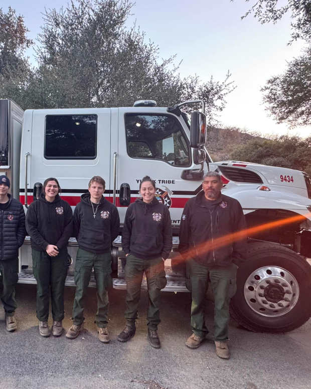 Members of the Yurok Nation fire department stand in front of a Yurok firefighting vehicle as they prepared to deploy to the Los Angeles area to fight wildfires. (Photo courtesy of Yurok Nation)