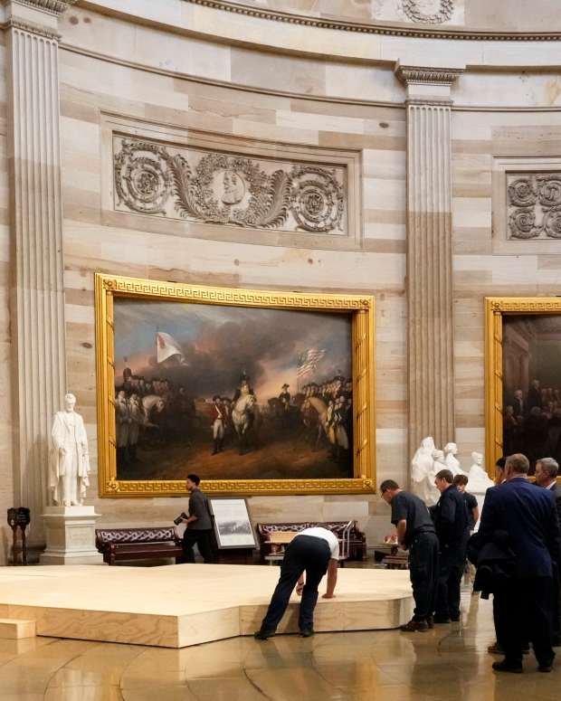 Workers build a stage in the U.S. Capitol Rotunda in Washington Friday, Jan. 17, 2025, for the 60th Presidential Inauguration which was moved indoors because of cold temperatures expected on Jan 20. (AP Photo/Morry Gash)   