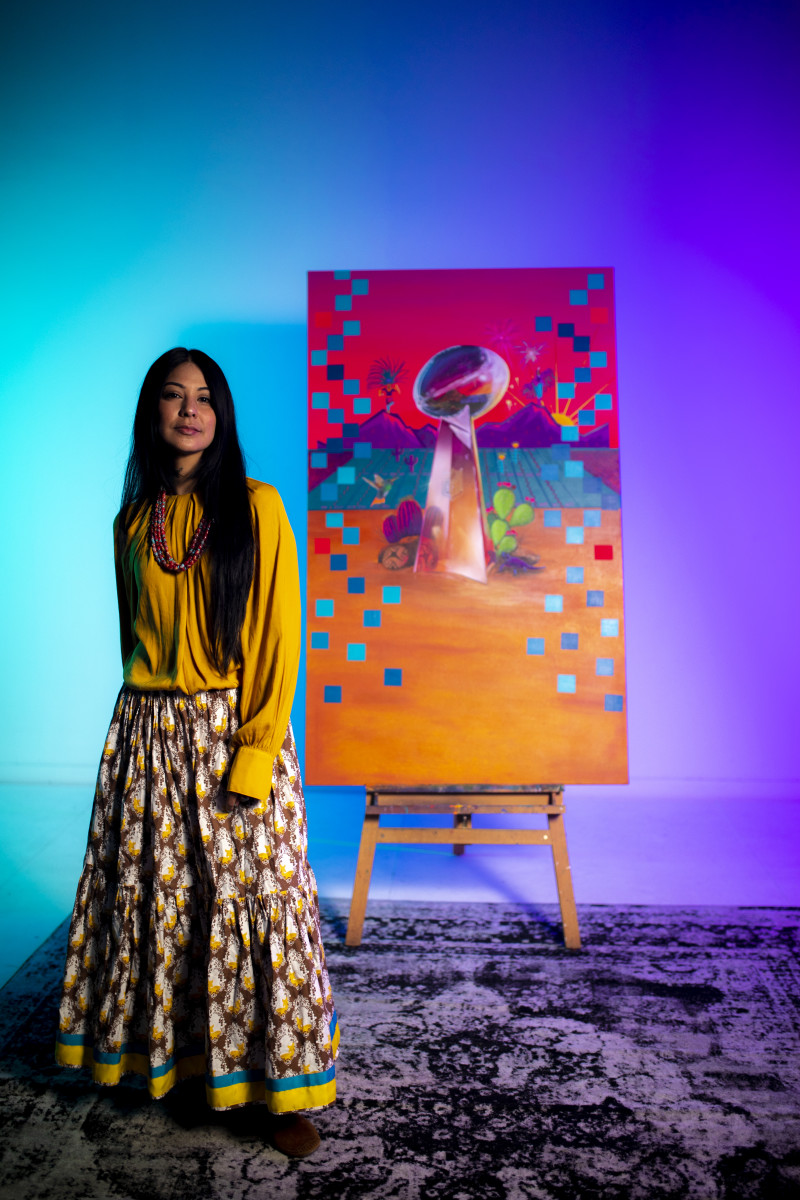 Phoenix-based artist Lucinda Hinojos, who has been tapped as the NFL's marquee artist for Super Bowl LVII, is shown in her studio with her featured design.  Her selection marks the first time an Indigenous artist’s works will be featured at the Super Bowl, which will be played on Feb. 12, 2023, in Glendale, Arizona. Hinojos is Mexican-American as well as Pascua Yaqui, Chiricahua Apache, White Mountain Apache, and Pima. (Photo courtesy of the National Football League)