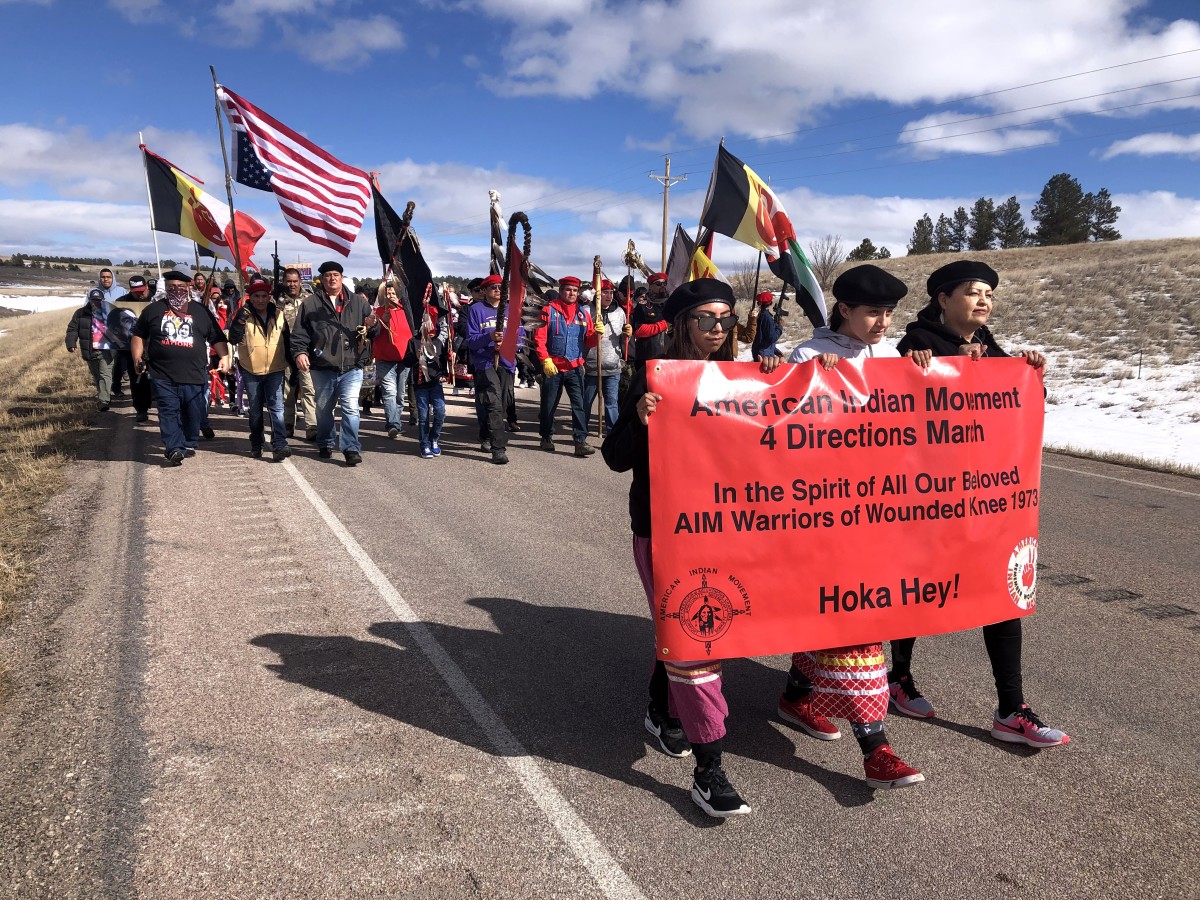 Wounded Knee Live Marchers With Red Banner Jpg 