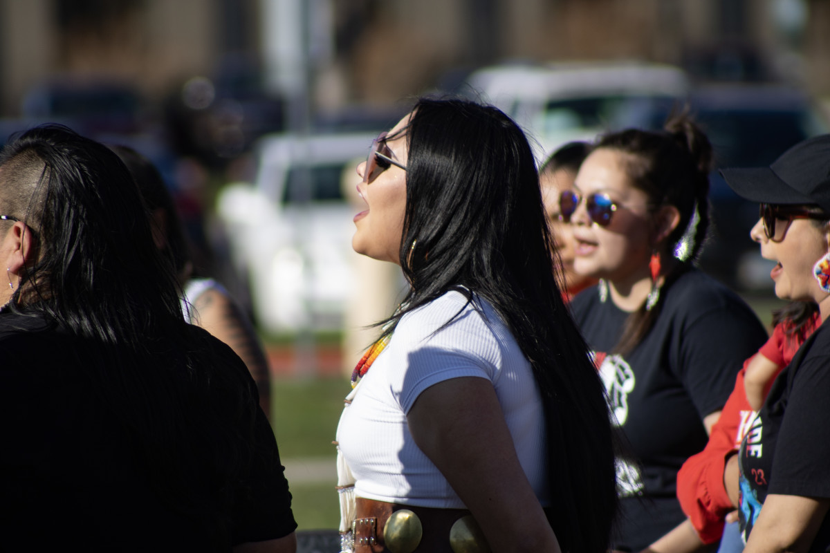 Cole Brings Plenty's cousin Breana sings during a vigil in honor of him on April 14 in Rapid City. (Photo by Amelia Schafer, ICT/Rapid City Journal)