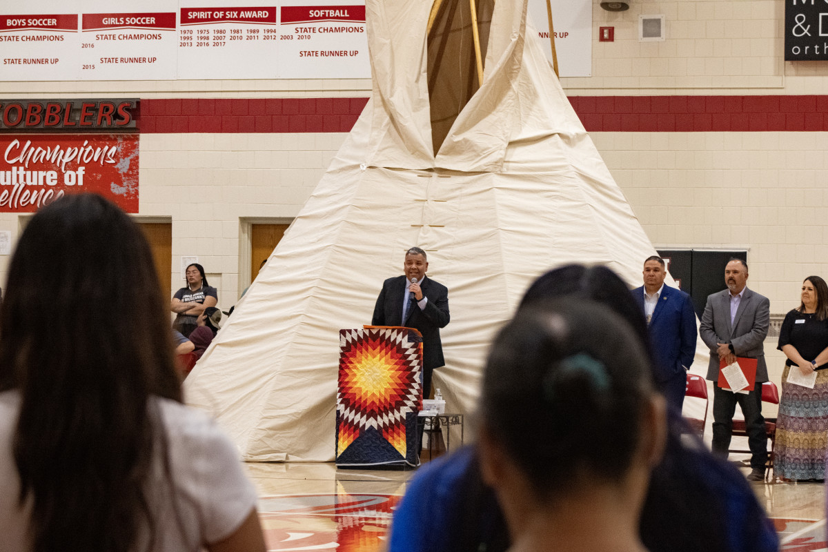 Rapid City Area Schools Title VI Director Ira Taken Alive addresses Native American Graduates during the 2024 feather-tying ceremony on May 22 at Central High School. (Photo by Amelia Schafer, ICT/Rapid City Journal)