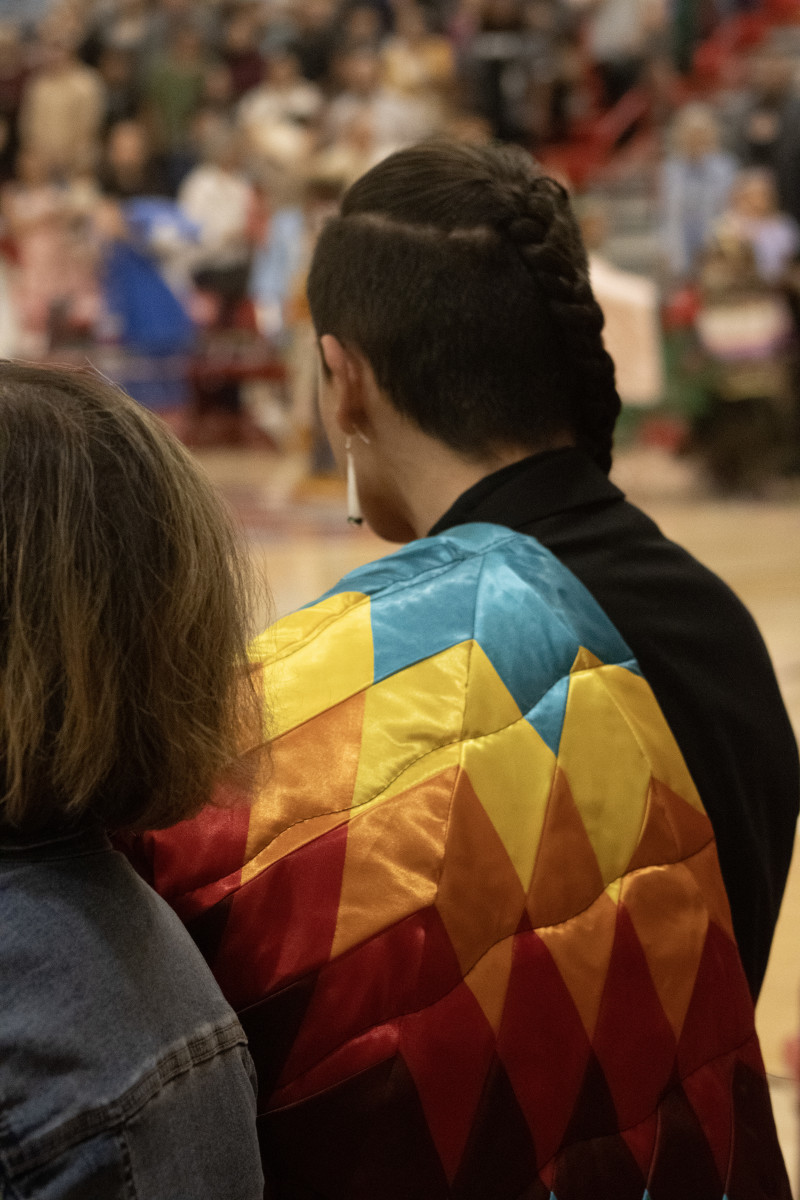 A Native graduate carries in his star quilt before the May 22 feather-tying ceremony at Central High School in Rapid City. (Photo by Amelia Schafer, ICT/Rapid City Journal)