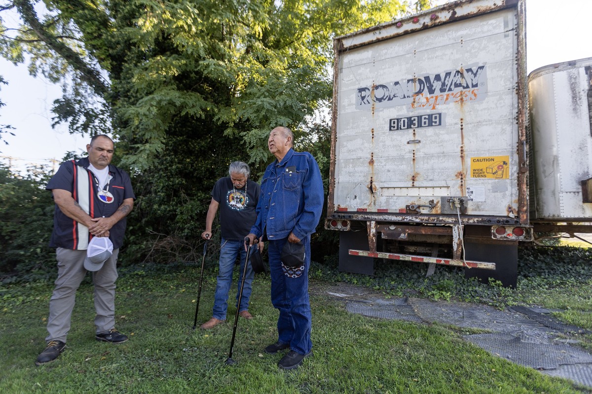 Three Oglala Sioux men - from left, Justin Pourier, Steve Dubray Sr. and Richard Moves Camp - searched the town of Carlisle, Pennsylvania, in September 2024 for this abandoned site on East Louther Street where Native students are believed to have arrived by train in the late 1800s to attend the Carlisle Indian Industrial School. The men came to perform a ceremony and to to be present for the disinterment of three Oglala students who died while attending the school more than 100 years ago - Fannie Charging Shield , Samuel Flying Horse, and James Cornman. The three were among  11 Native youths wwho were to be disinterred from the Carlisle Barracks Post Cemetery starting Sept. 6, 2024, and repatriated to their homelands. (Photo by Charles Fox, special to ICT)