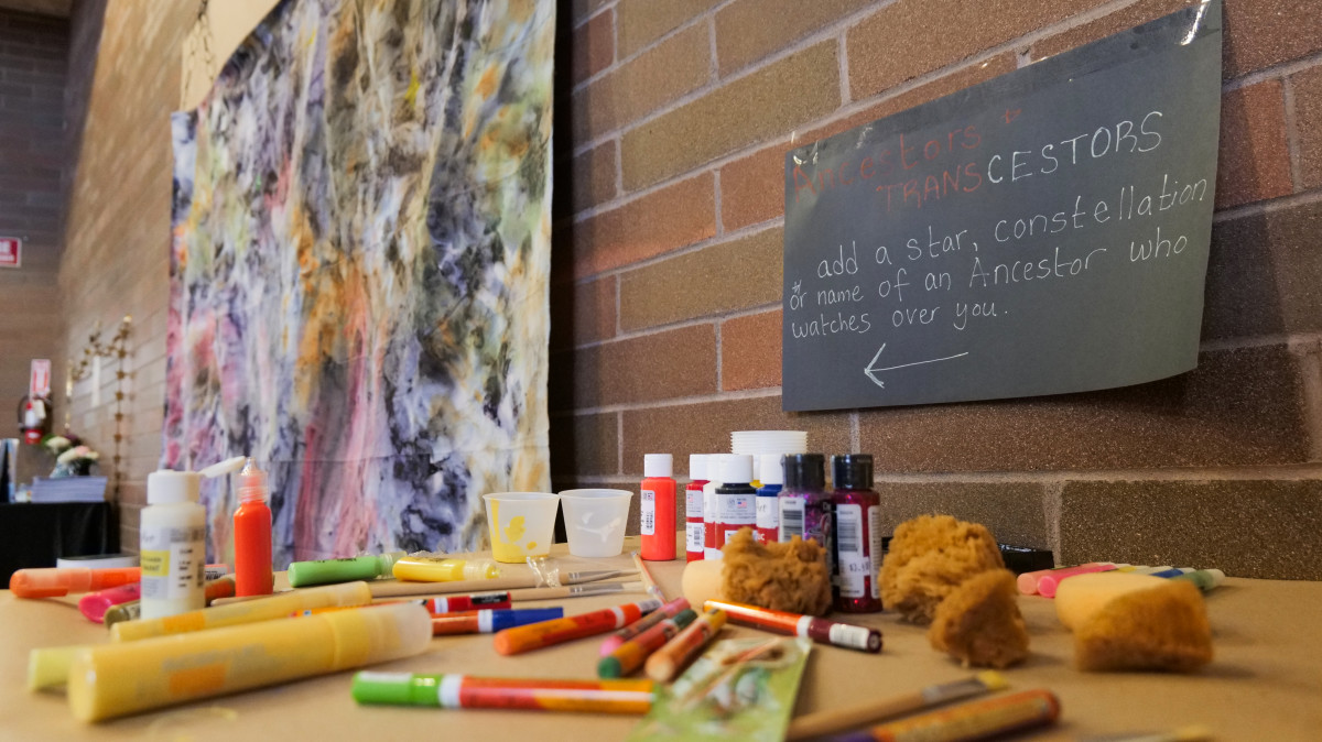 Attendees were encouraged to add a star and name of an ancestor who watches over them to a tie dyed canvas hanging on the wall on Sept. 14, 2024 at Barbie's Village. (Photo by Jarrette Werk Underscore Native News / Report for America)