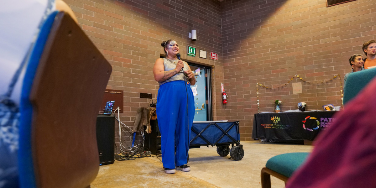 Mick Rose, Diné, Omaha, and Pawnee Nations, an Indigiqueer non-binary person, welcomed attendees to the book launch and reading of “Cosmo, From the Stars,” on Sept. 14, 2024 at Barbie's Village. (Photo by Jarrette Werk Underscore Native News / Report for America)