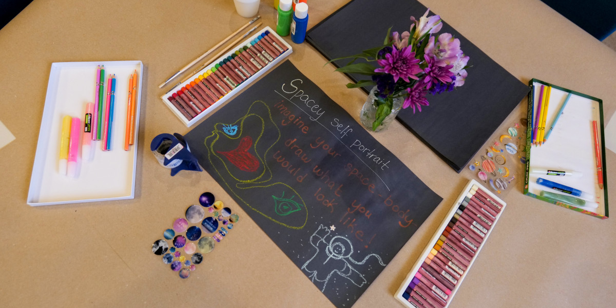 During the book launch for “Cosmo, From the Stars” on Sept. 14, 2024 at Barbie's Village, which shares the story of a young Two Spirit person, art stations were set up for attendees such as this one where people were encouraged to draw a spacey self portrait. (Photo by Jarrette Werk Underscore Native News / Report for America)