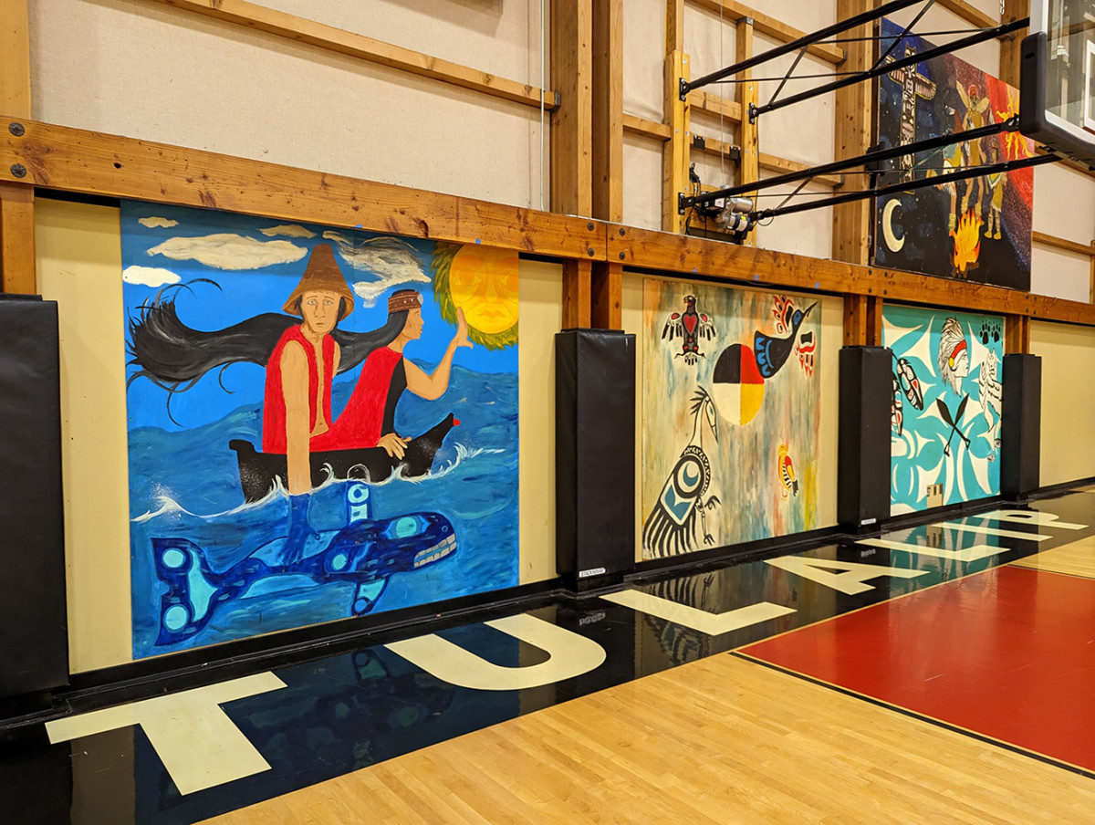 The murals in Tulalip Tribes Youth Council gymnasium have remained unchanged since Andres “Dre” Thornock visited as a child. The art depicts the salmon and the whale, which historically provided sustenance for Tulalip peoples. (Nancy Marie Spears, The Imprint)