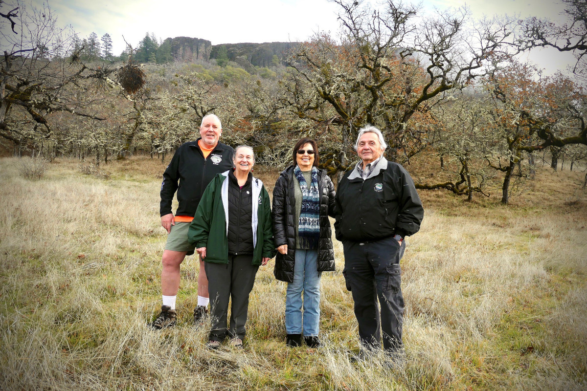 Siletz Tribal Council members left to right: Robert Kentta, treasurer; July Muschamp, secretary; Delores Pigsley, chairman; and Gerald Ben on the newly purchased Table Rock property. (Photo by Matt Hill, Lone Rock Strategies)