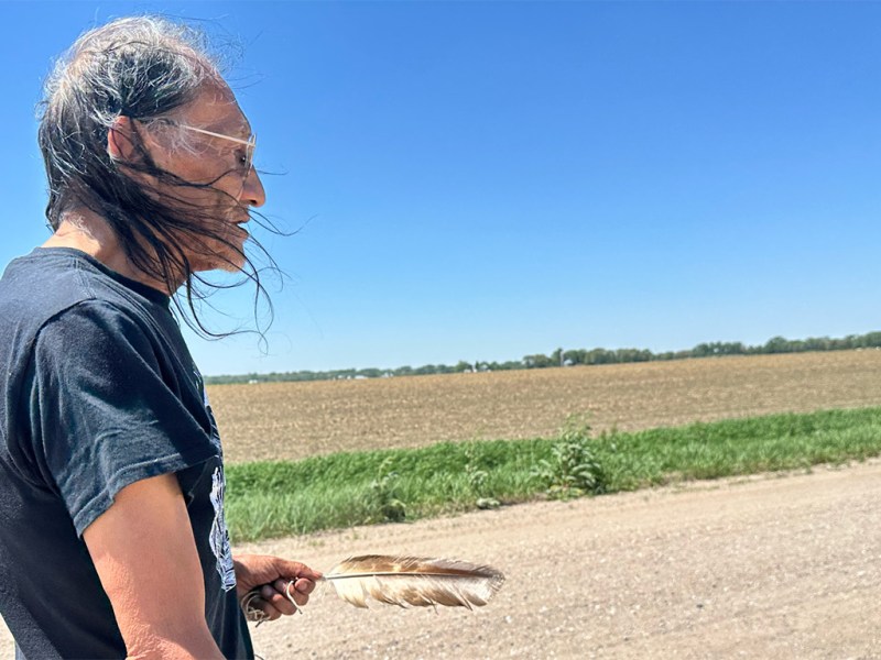 Nathan Phillips walks along a rural road in Genoa, Nebraska, on May 12, 2025, during a memorial honoring children of the former U.S. Indian Industrial School.