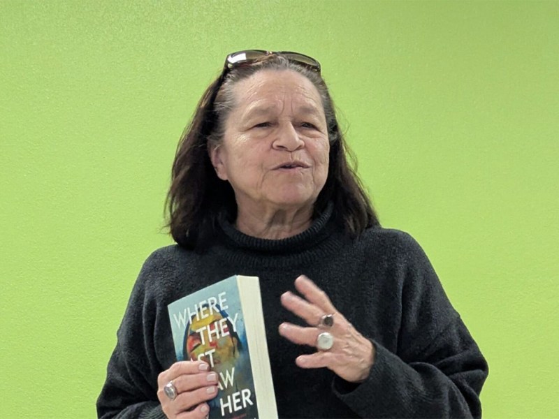 Author Marcie Rendon speaks while holding her book “Where They Last Saw Her” during an event at the Muir Library in Winnebago, Minnesota.