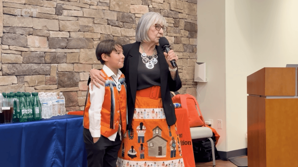 boarding school survivor shares story while hugging grandson