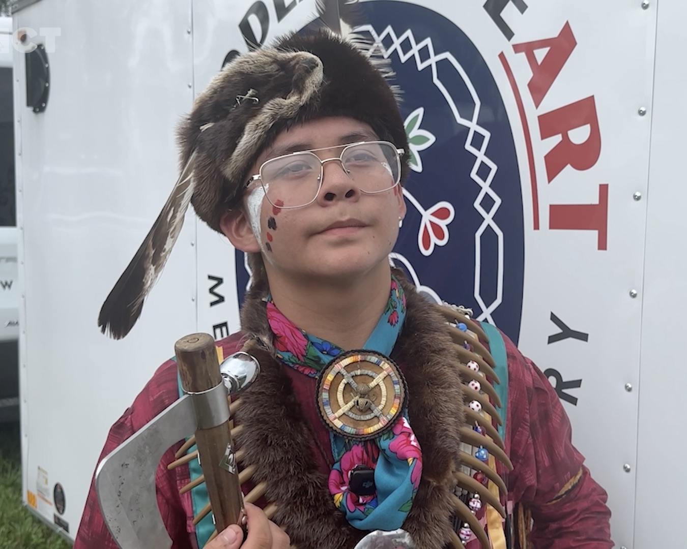 Menominee youth powwow dancer Adrian Silas wears traditional regalia